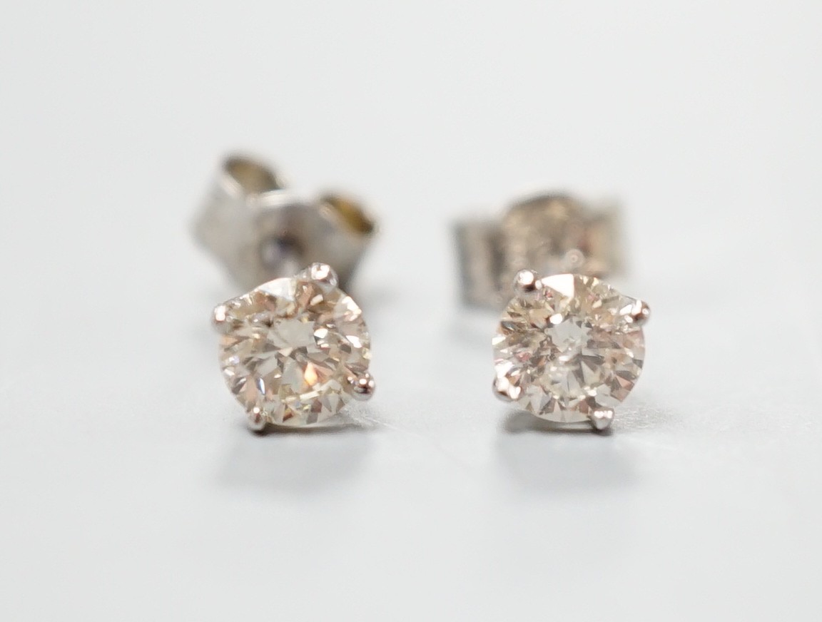 A pair of white metal and solitaire diamond set ear studs, gross weight 0.8 grams, stone diameter approx. 3.5mm.